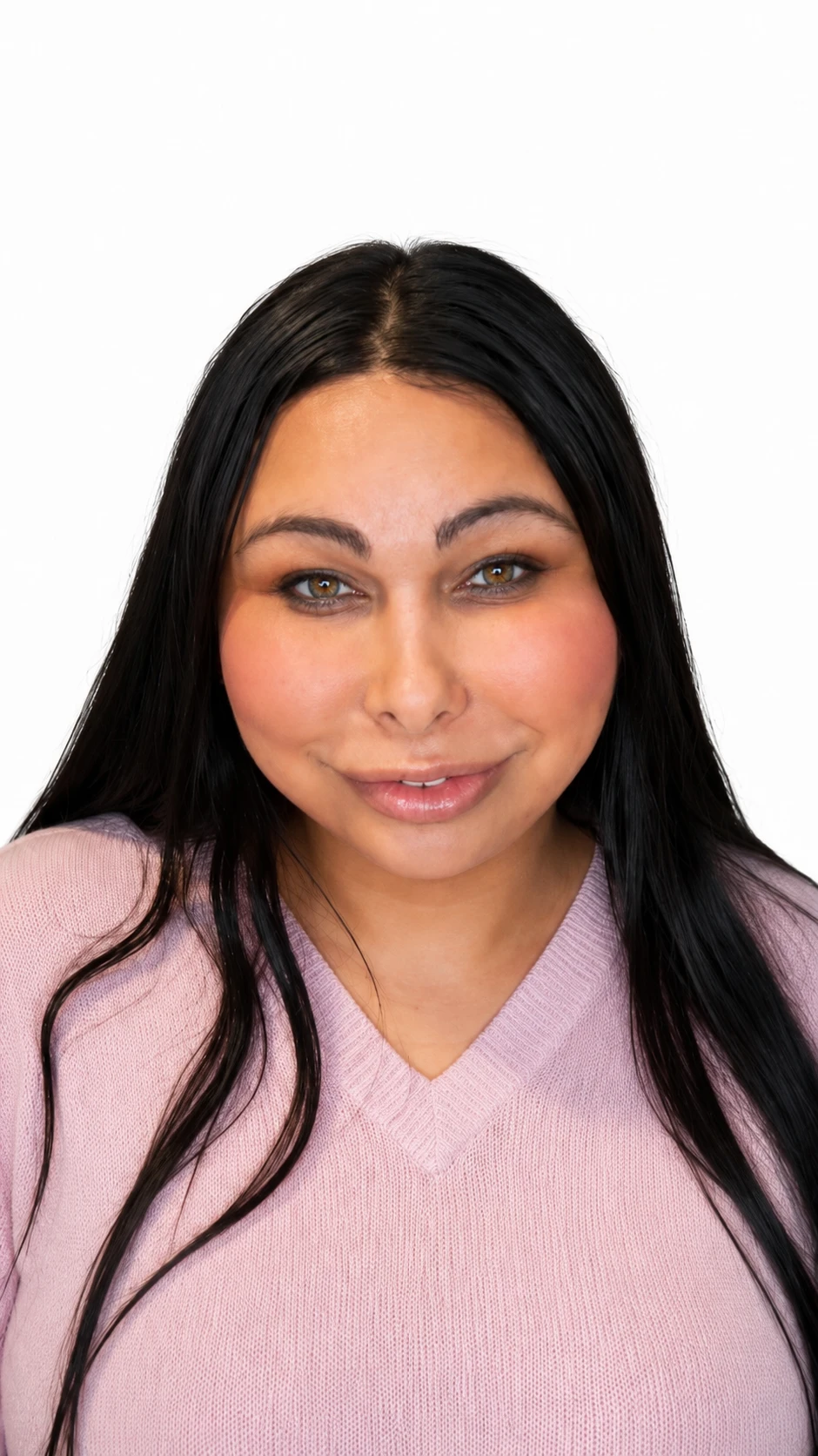 Day Quinn smiling in a pink sweater against a white background